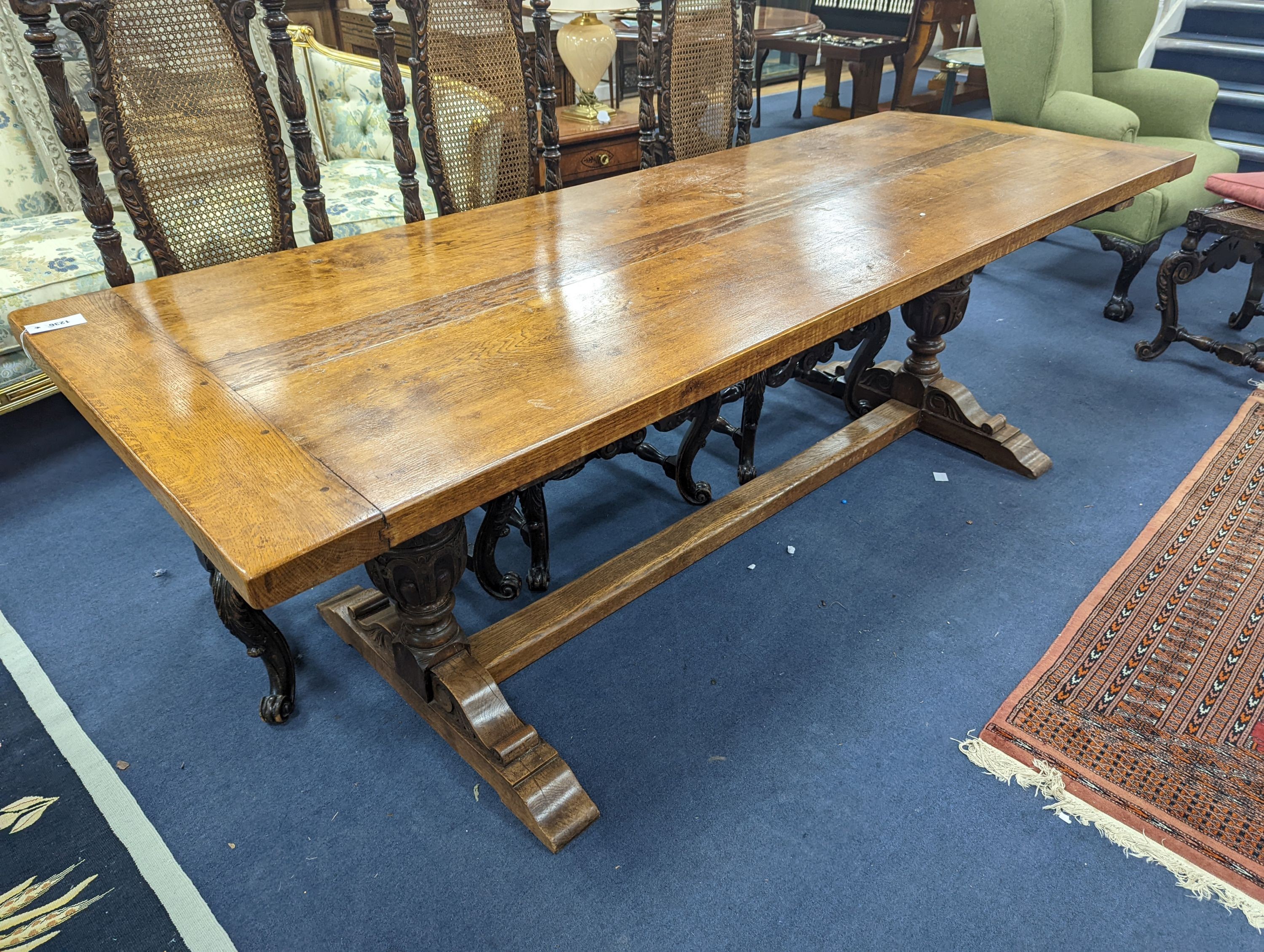 An 18th century style rectangular oak refectory dining table with central stretcher, length 230cm, depth 80cm, height 74cm